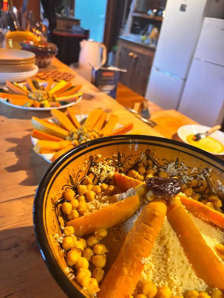 A big bowl of couscous with chickpeas and carrots on the wooden bar