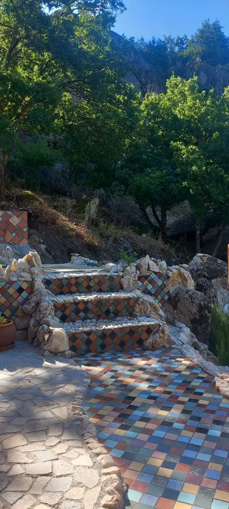 A mosaic path leading to stone steps