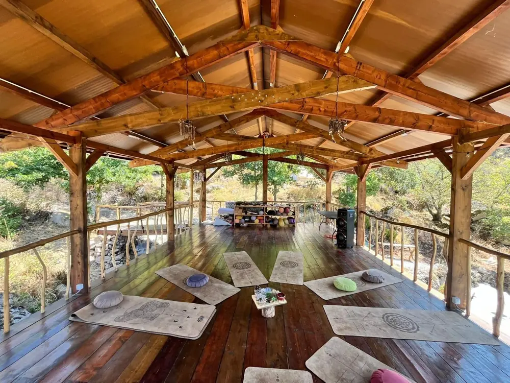 The open-air practice deck with mats and cushions